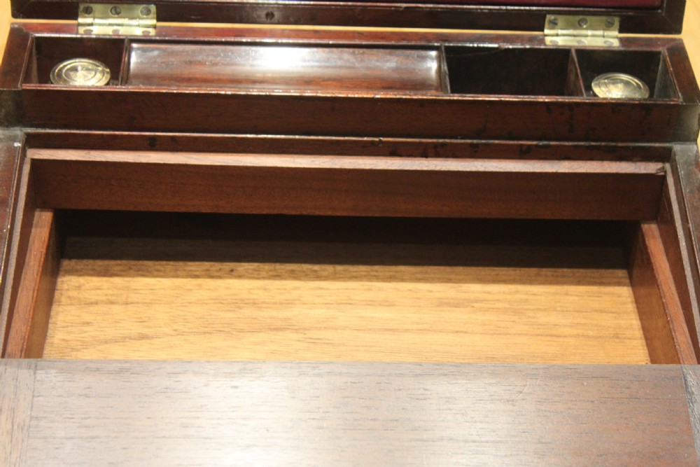 A closed rectangular late Georgian mahogany campaign writing slope featuring flush brass corner brackets, protective straps, and a decorative brass keyhole escutcheon. View XIII