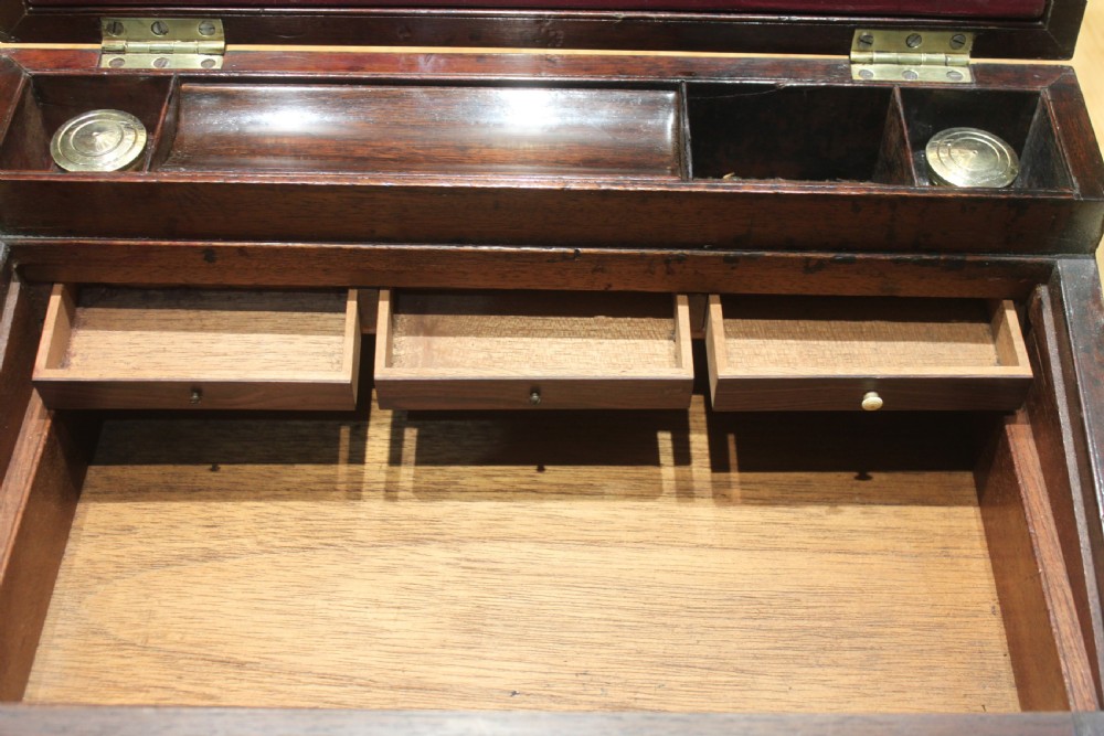 A closed rectangular late Georgian mahogany campaign writing slope featuring flush brass corner brackets, protective straps, and a decorative brass keyhole escutcheon. View XV