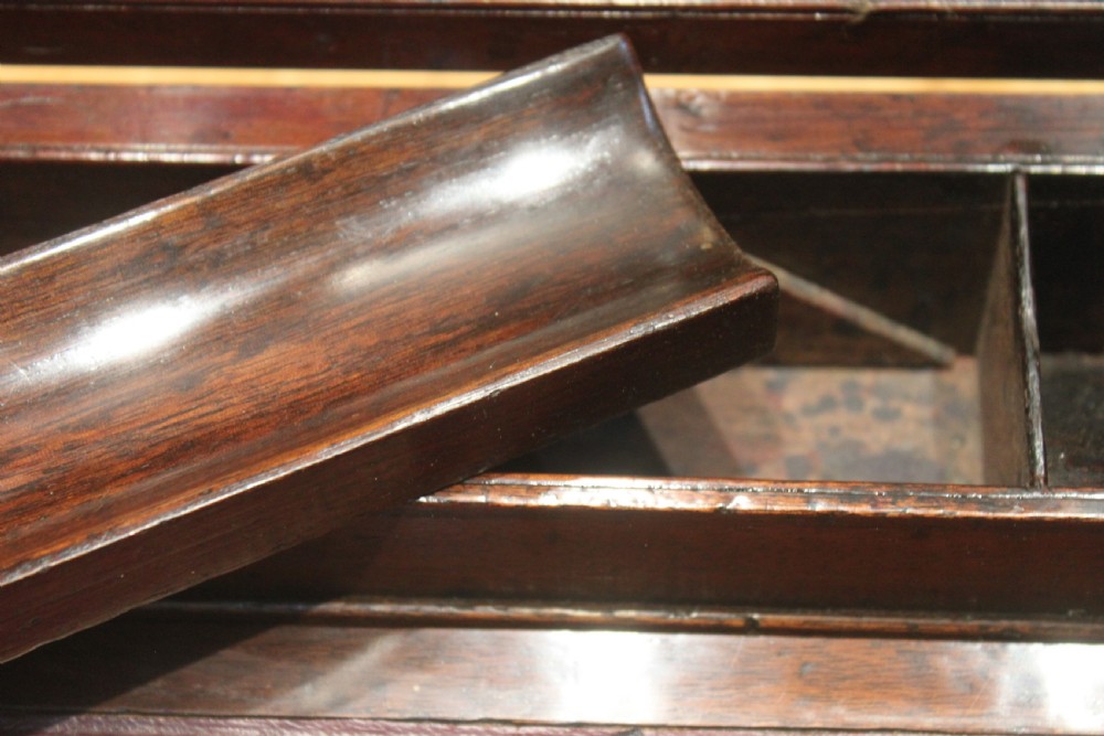 A closed rectangular late Georgian mahogany campaign writing slope featuring flush brass corner brackets, protective straps, and a decorative brass keyhole escutcheon. View XVIII