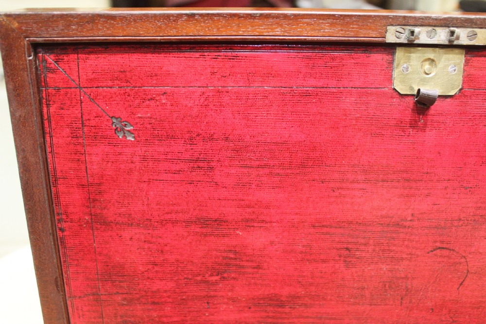 A 19th-century rectangular mahogany campaign writing slope with flush brass corner brackets, brass side strapping, an inlaid brass keyhole escutcheon, and a central brass plaque on the lid. View XIII