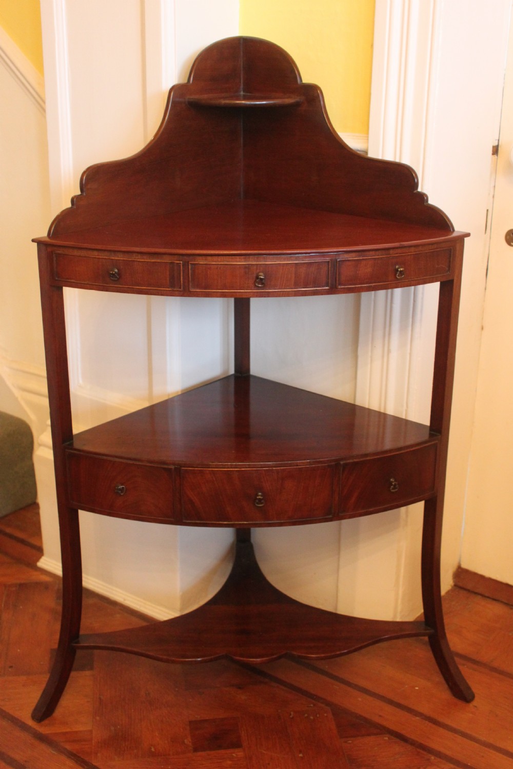 A George III period two tier mahogany  corner wash stand