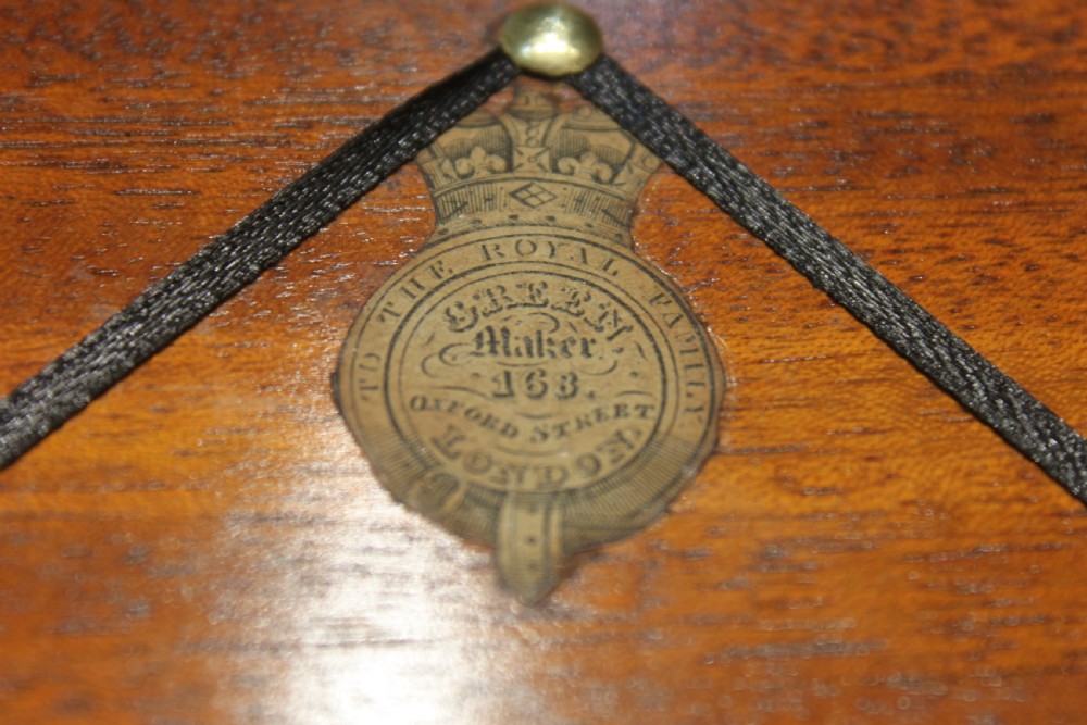 A closed rectangular dark rosewood writing slope featuring brass-bound corners, fine brass line inlay, a brass keyhole escutcheon, and an engraved central brass cartouche. View XI