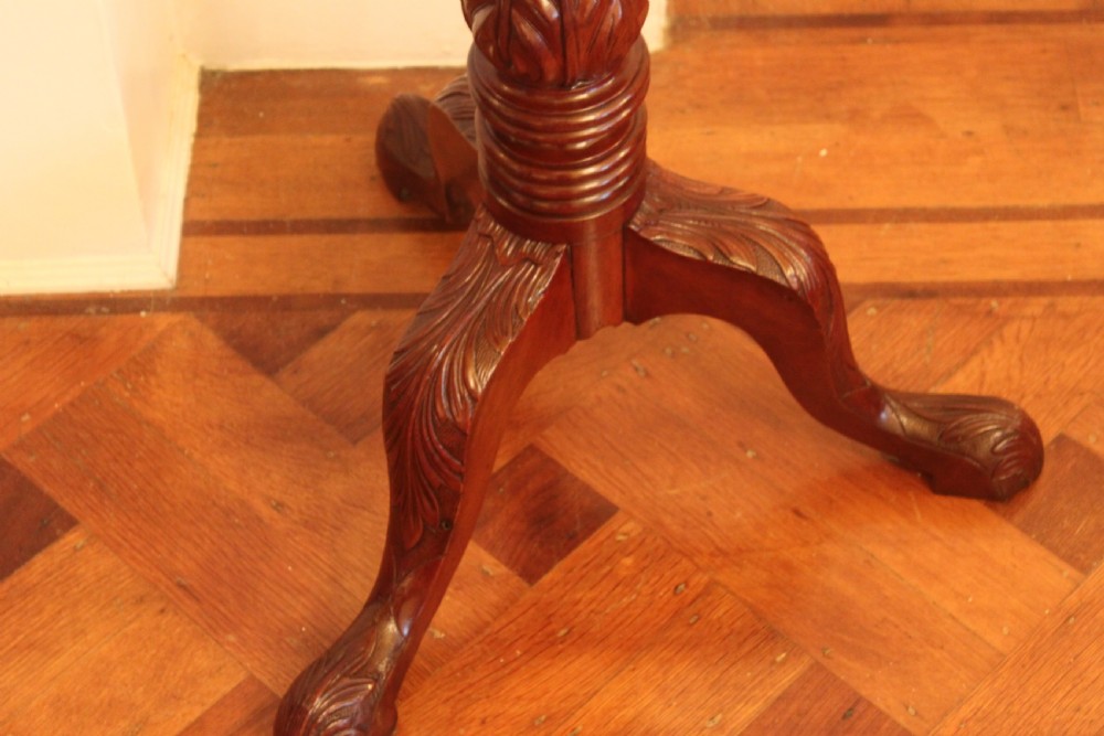 A tall nineteenth-century dark mahogany torchiere stand featuring a carved spiral twist column, acanthus leaf motifs, and a tripod base. View II