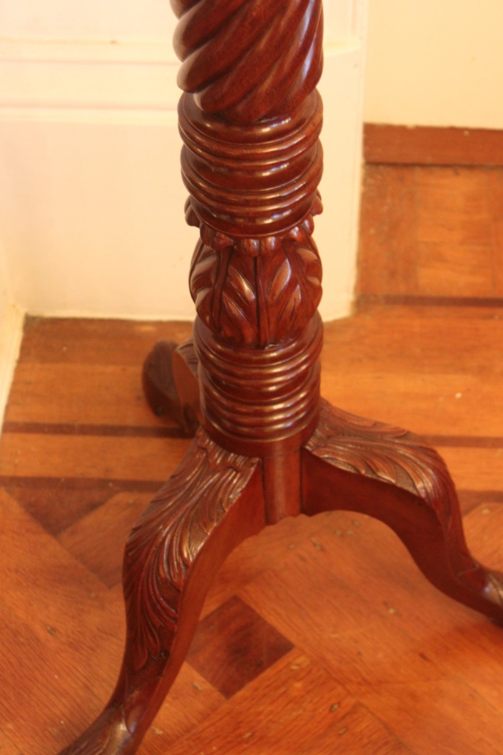 A tall nineteenth-century dark mahogany torchiere stand featuring a carved spiral twist column, acanthus leaf motifs, and a tripod base. View III
