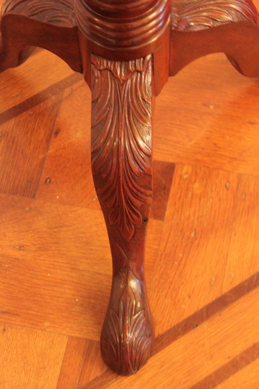 A tall nineteenth-century dark mahogany torchiere stand featuring a carved spiral twist column, acanthus leaf motifs, and a tripod base. View VI
