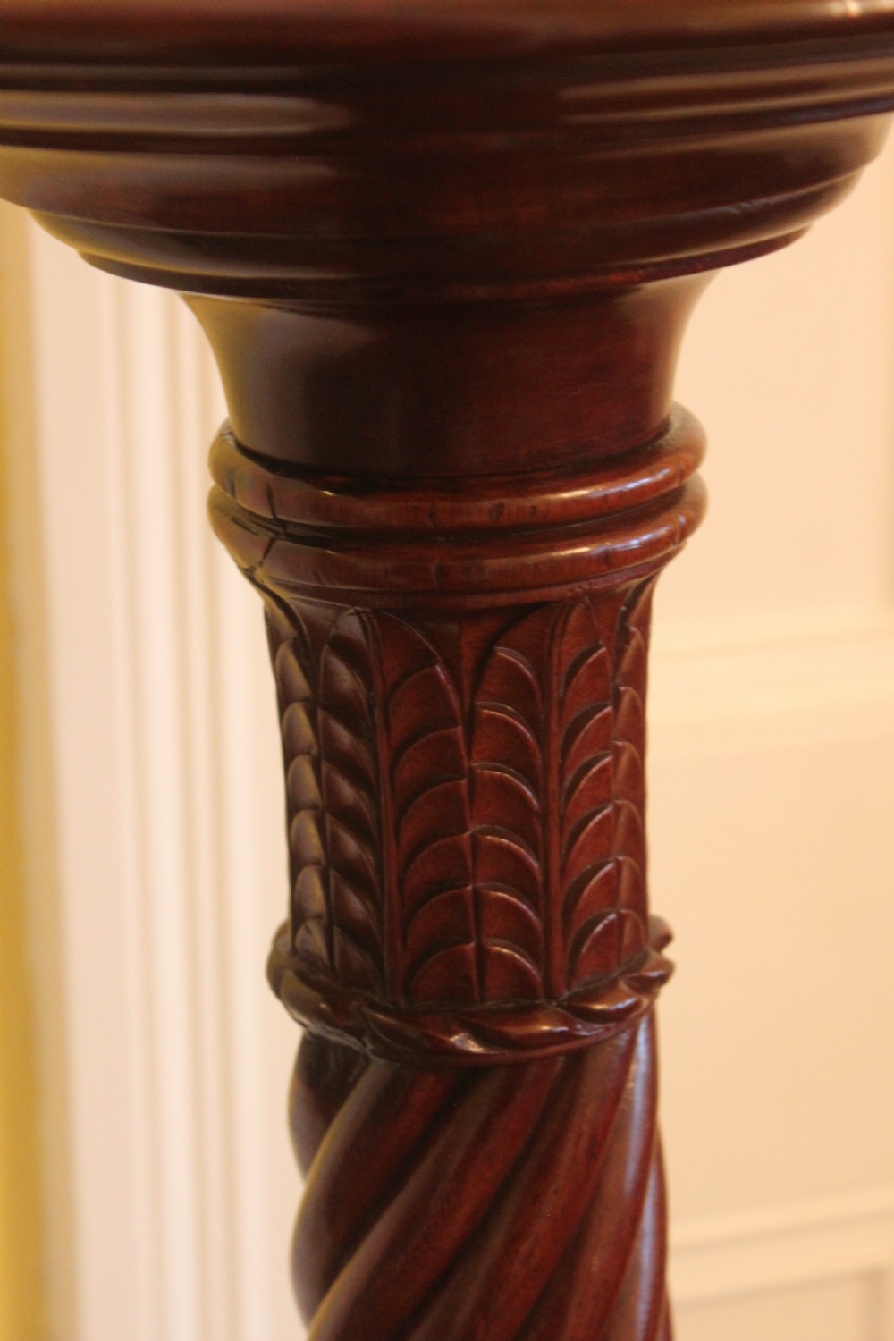 A tall nineteenth-century dark mahogany torchiere stand featuring a carved spiral twist column, acanthus leaf motifs, and a tripod base. View VII
