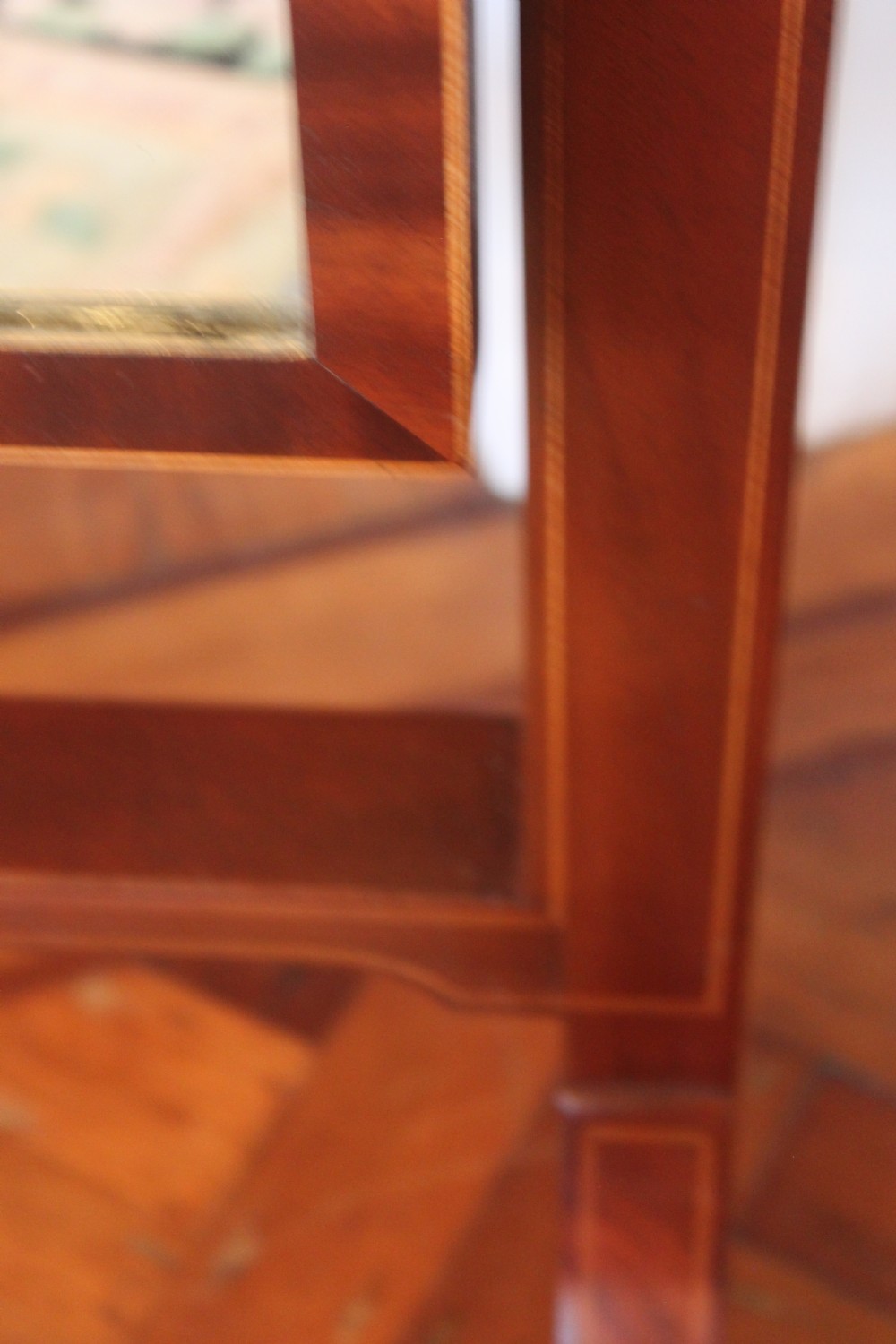 A full-length Sheraton style mahogany cheval dressing mirror with turned finials, splayed legs, brass castors, and a tilting frame. View V