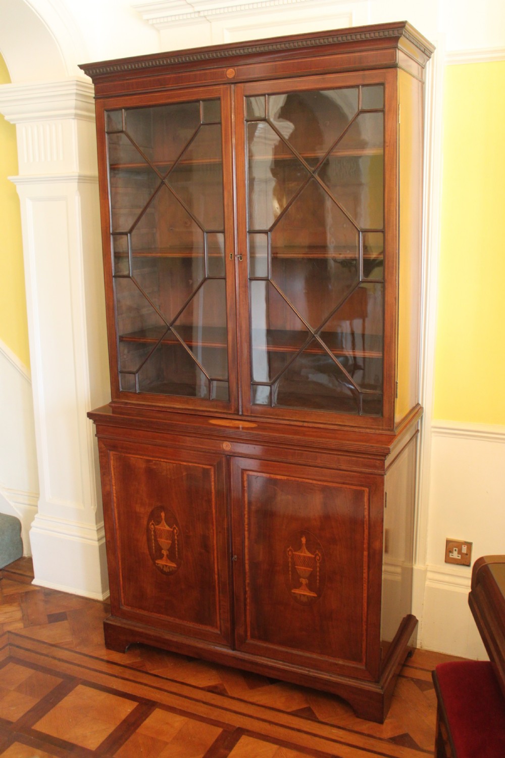 A late 19th Century inlaid mahogany Sheraton Revival library bookcase