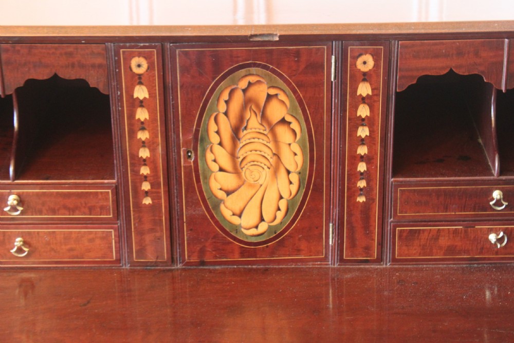 An 18th-century George III mahogany slant-front bureau featuring brass swan-neck handles and inlaid stringing over four graduated drawers. View III