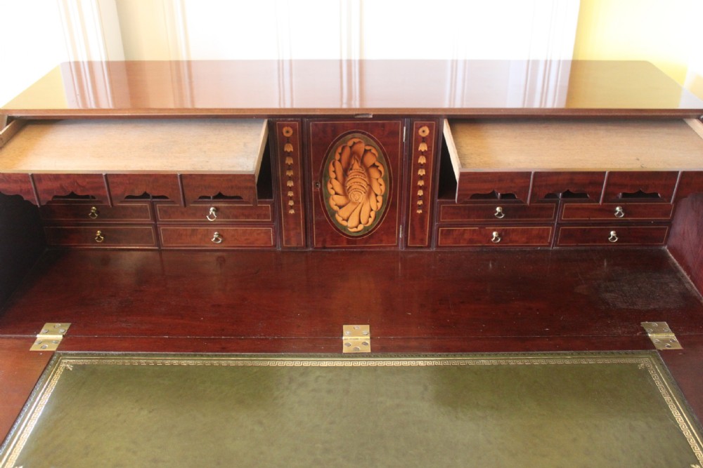 An 18th-century George III mahogany slant-front bureau featuring brass swan-neck handles and inlaid stringing over four graduated drawers. View VI