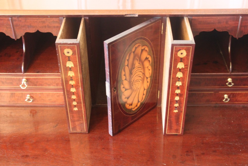 An 18th-century George III mahogany slant-front bureau featuring brass swan-neck handles and inlaid stringing over four graduated drawers. View VII