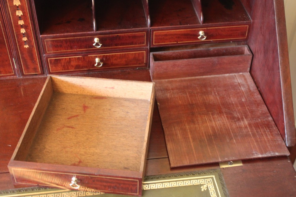 An 18th-century George III mahogany slant-front bureau featuring brass swan-neck handles and inlaid stringing over four graduated drawers. View VIII