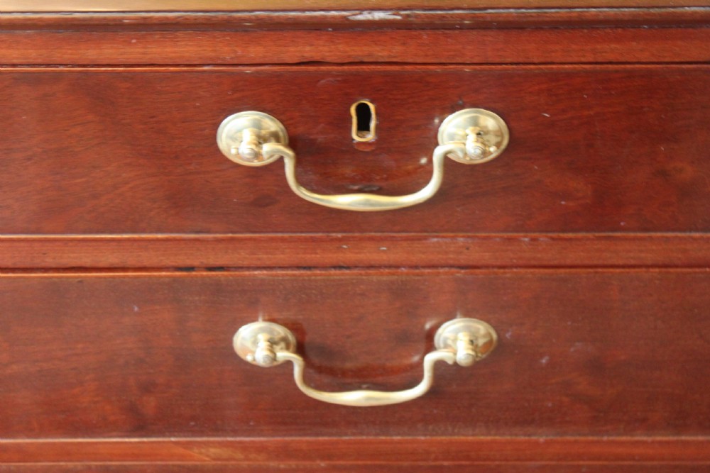 An 18th-century George III mahogany slant-front bureau featuring brass swan-neck handles and inlaid stringing over four graduated drawers. View XIII