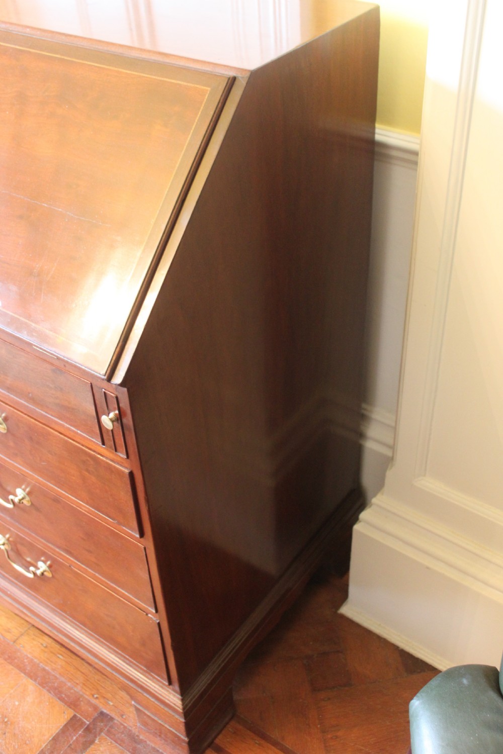 An 18th-century George III mahogany slant-front bureau featuring brass swan-neck handles and inlaid stringing over four graduated drawers. View XV