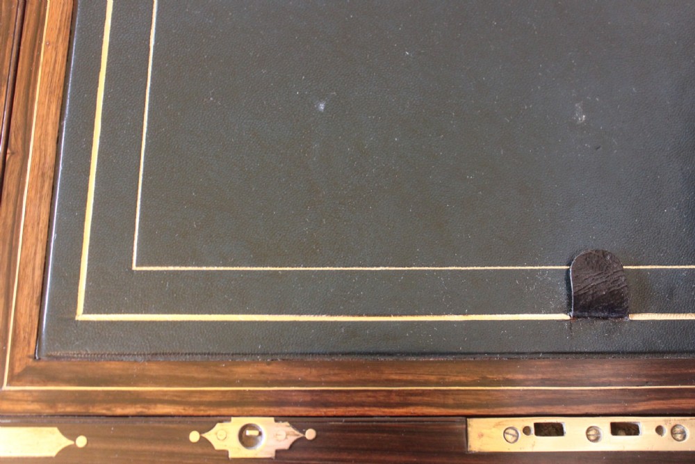 A rectangular Victorian burr walnut writing slope box featuring swirl veneer patterns, brass stringing inlay, a central engraved brass plaque, and a front keyhole escutcheon. View VIII