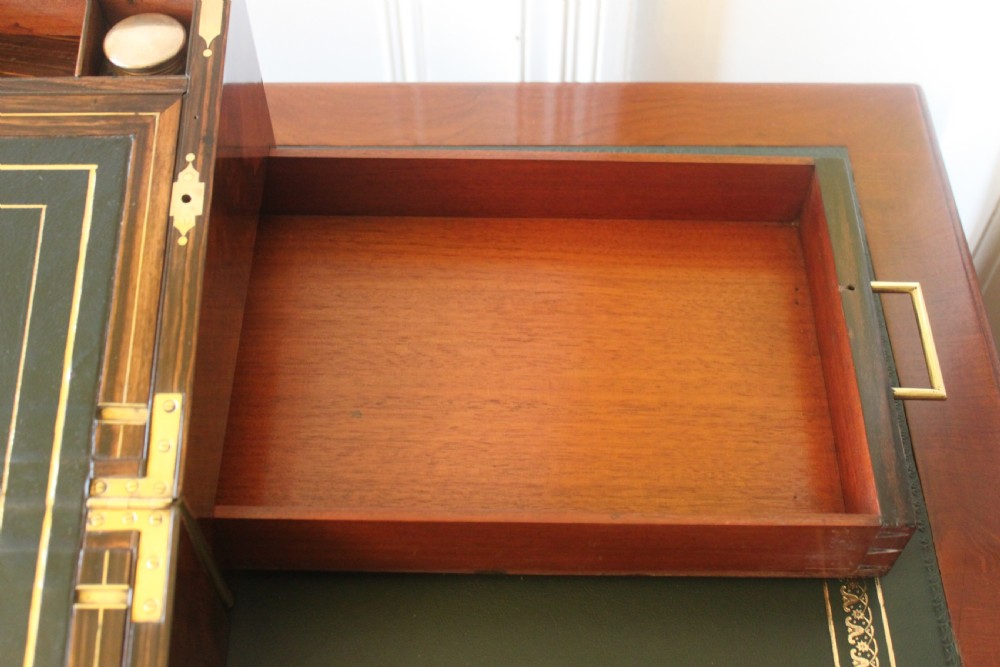 A rectangular Victorian burr walnut writing slope box featuring swirl veneer patterns, brass stringing inlay, a central engraved brass plaque, and a front keyhole escutcheon. View XI