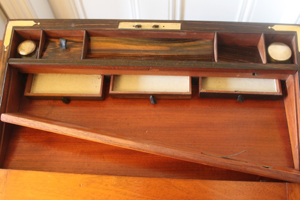 A rectangular Victorian burr walnut writing slope box featuring swirl veneer patterns, brass stringing inlay, a central engraved brass plaque, and a front keyhole escutcheon. View XIII