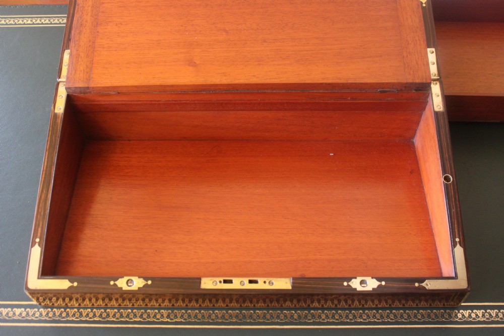 A rectangular Victorian burr walnut writing slope box featuring swirl veneer patterns, brass stringing inlay, a central engraved brass plaque, and a front keyhole escutcheon. View XV