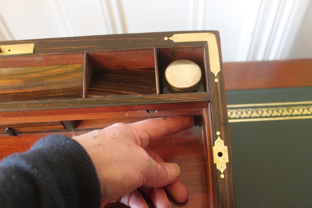 A rectangular Victorian burr walnut writing slope box featuring swirl veneer patterns, brass stringing inlay, a central engraved brass plaque, and a front keyhole escutcheon. View XVI