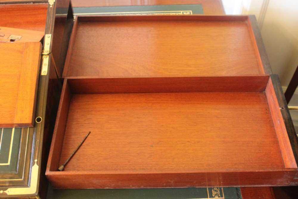 A rectangular Victorian burr walnut writing slope box featuring swirl veneer patterns, brass stringing inlay, a central engraved brass plaque, and a front keyhole escutcheon. View XVII