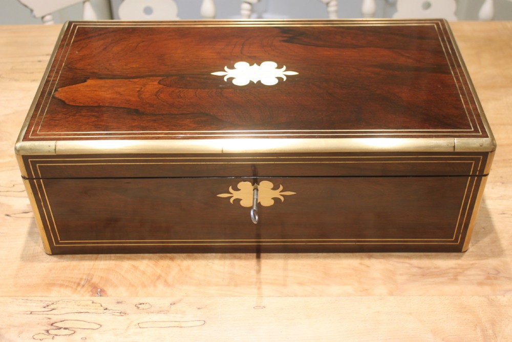 A large 19th century rosewood writing slope with brass inlay