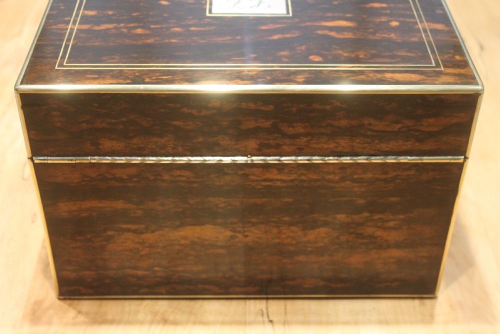 A rectangular Victorian coromandel wood dressing box with fine brass line inlay and a central monogram cartouche on the lid. View IV