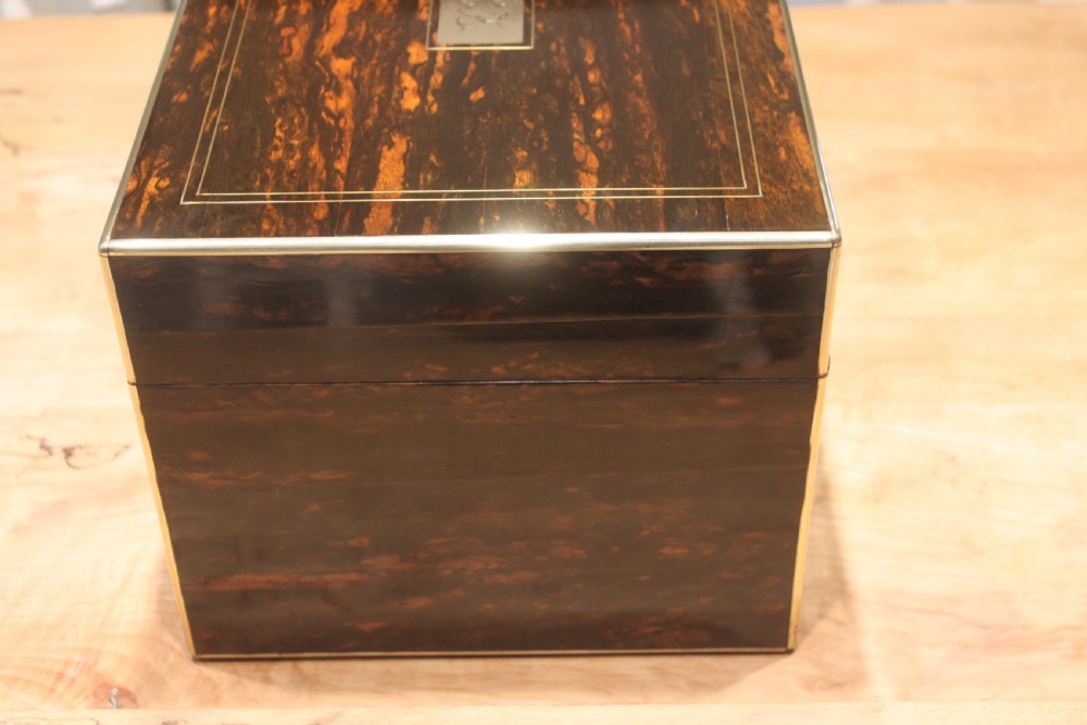 A rectangular Victorian coromandel wood dressing box with fine brass line inlay and a central monogram cartouche on the lid. View V