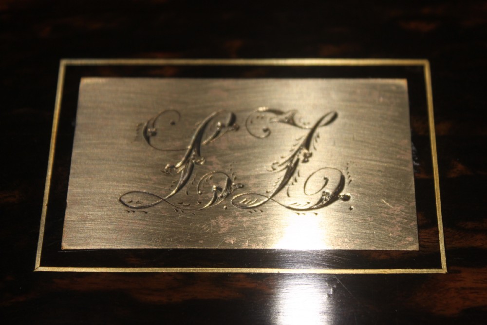 A rectangular Victorian coromandel wood dressing box with fine brass line inlay and a central monogram cartouche on the lid. View VI