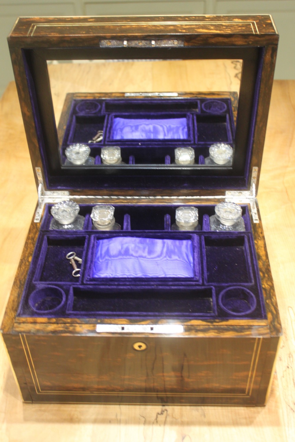 A rectangular Victorian coromandel wood dressing box with fine brass line inlay and a central monogram cartouche on the lid. View VII