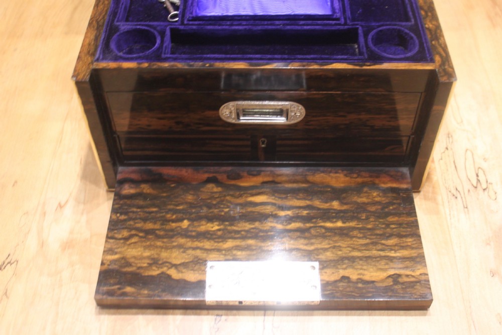 A rectangular Victorian coromandel wood dressing box with fine brass line inlay and a central monogram cartouche on the lid. View VIII