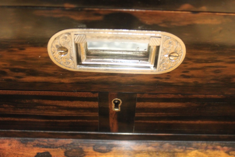 A rectangular Victorian coromandel wood dressing box with fine brass line inlay and a central monogram cartouche on the lid. View X
