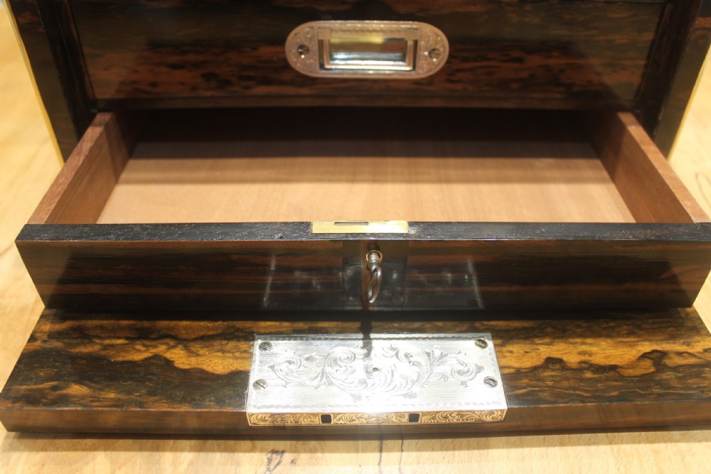 A rectangular Victorian coromandel wood dressing box with fine brass line inlay and a central monogram cartouche on the lid. View XII