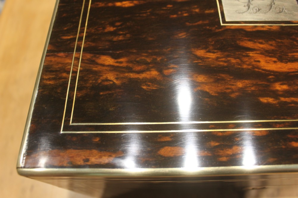 A rectangular Victorian coromandel wood dressing box with fine brass line inlay and a central monogram cartouche on the lid. View XVII