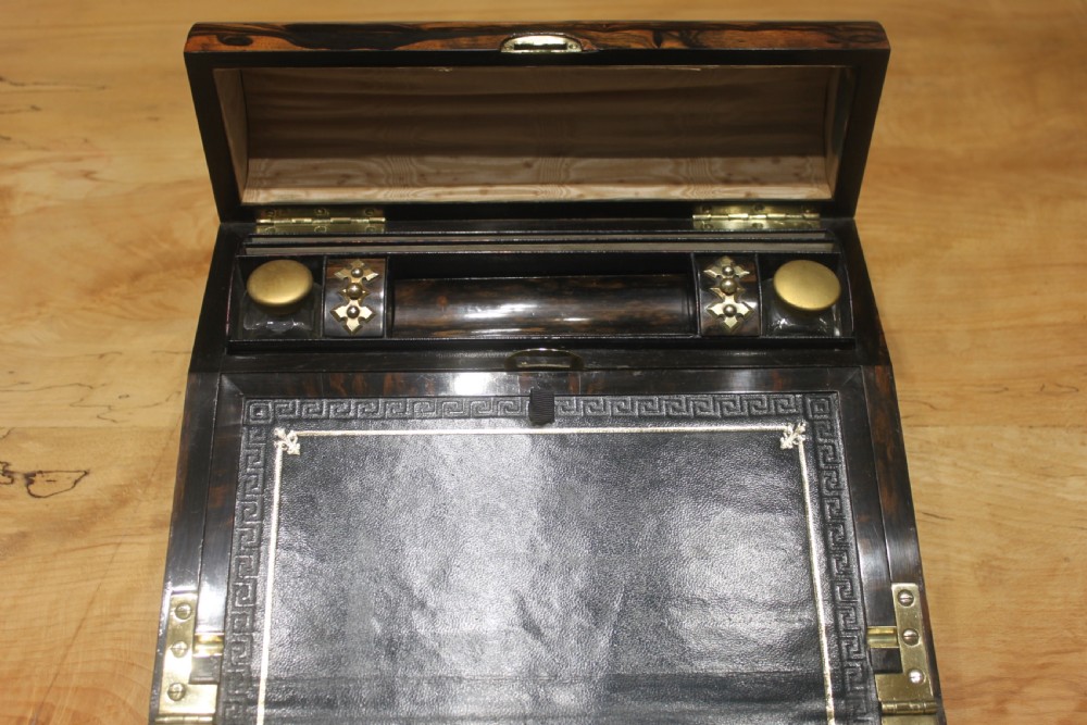 A Victorian coromandel wood writing slope featuring distinct dark and golden brown grain patterns, a rounded top section, and a central brass keyhole. View VII
