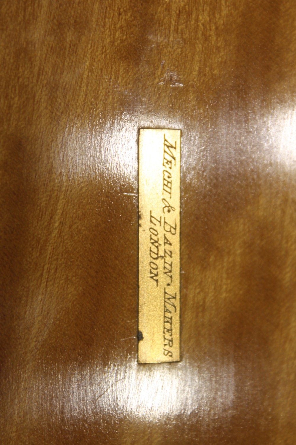 A Victorian coromandel wood writing slope featuring distinct dark and golden brown grain patterns, a rounded top section, and a central brass keyhole. View XI