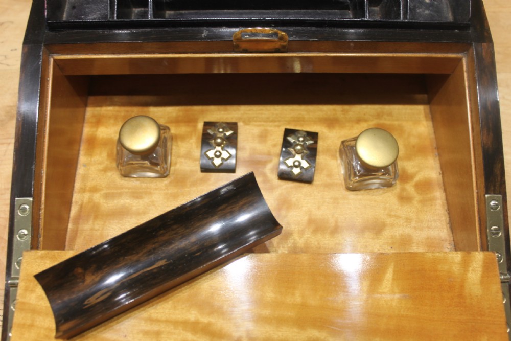 A Victorian coromandel wood writing slope featuring distinct dark and golden brown grain patterns, a rounded top section, and a central brass keyhole. View XII