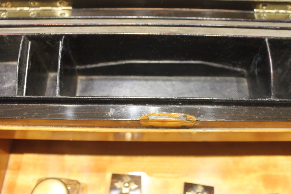 A Victorian coromandel wood writing slope featuring distinct dark and golden brown grain patterns, a rounded top section, and a central brass keyhole. View XIII