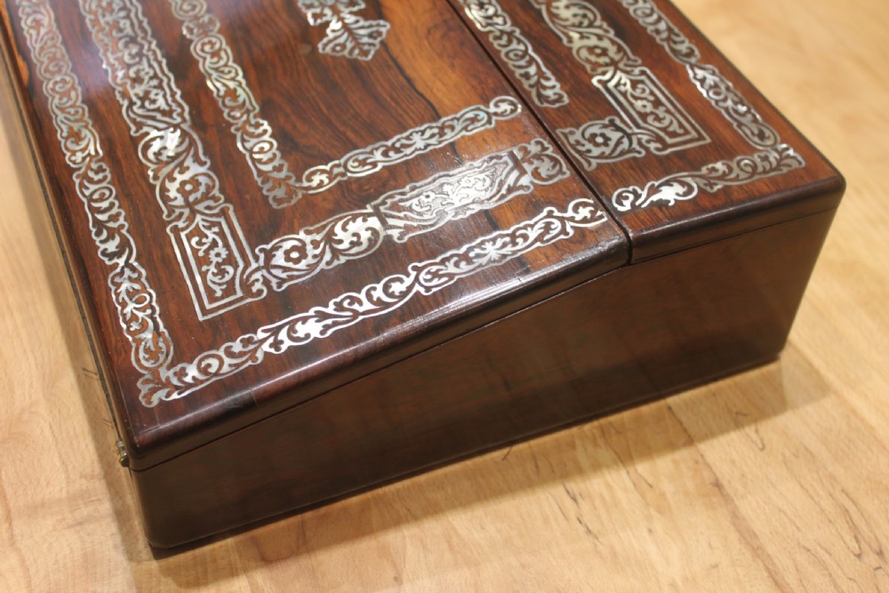 A dark rosewood rectangular writing slope box decorated with intricate mother-of-pearl foliate floral inlay and a central keyhole escutcheon. View III