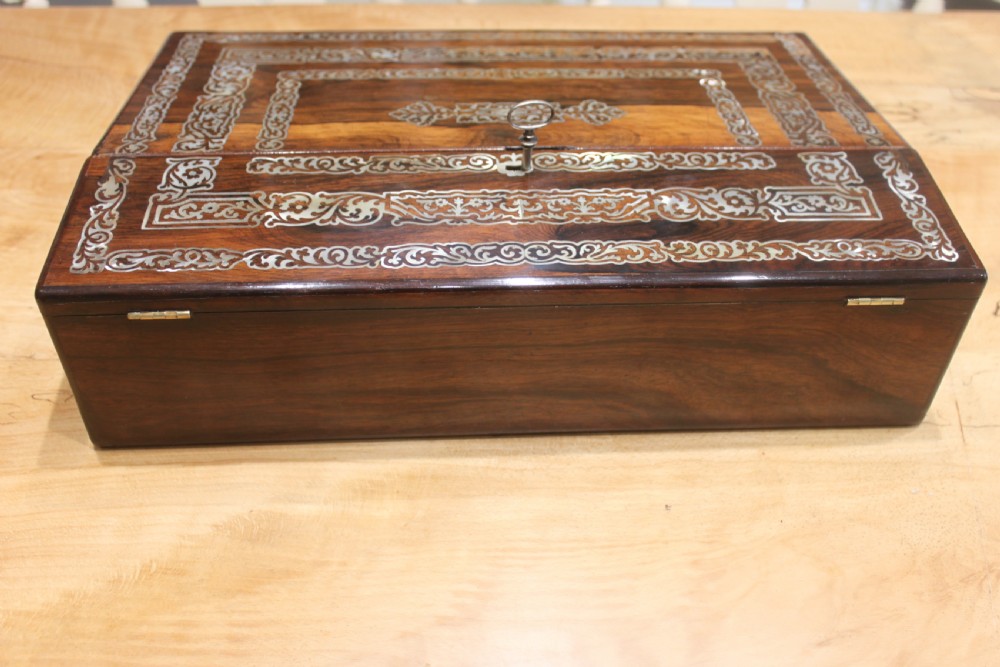 A dark rosewood rectangular writing slope box decorated with intricate mother-of-pearl foliate floral inlay and a central keyhole escutcheon. View IV
