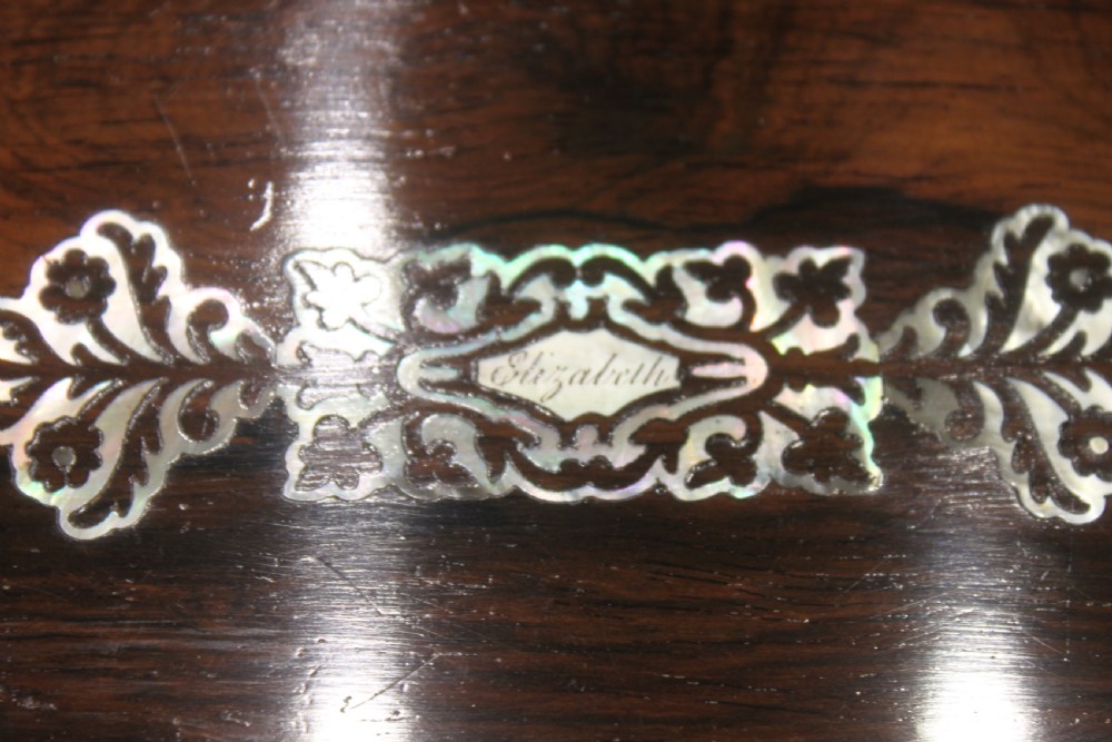 A dark rosewood rectangular writing slope box decorated with intricate mother-of-pearl foliate floral inlay and a central keyhole escutcheon. View V