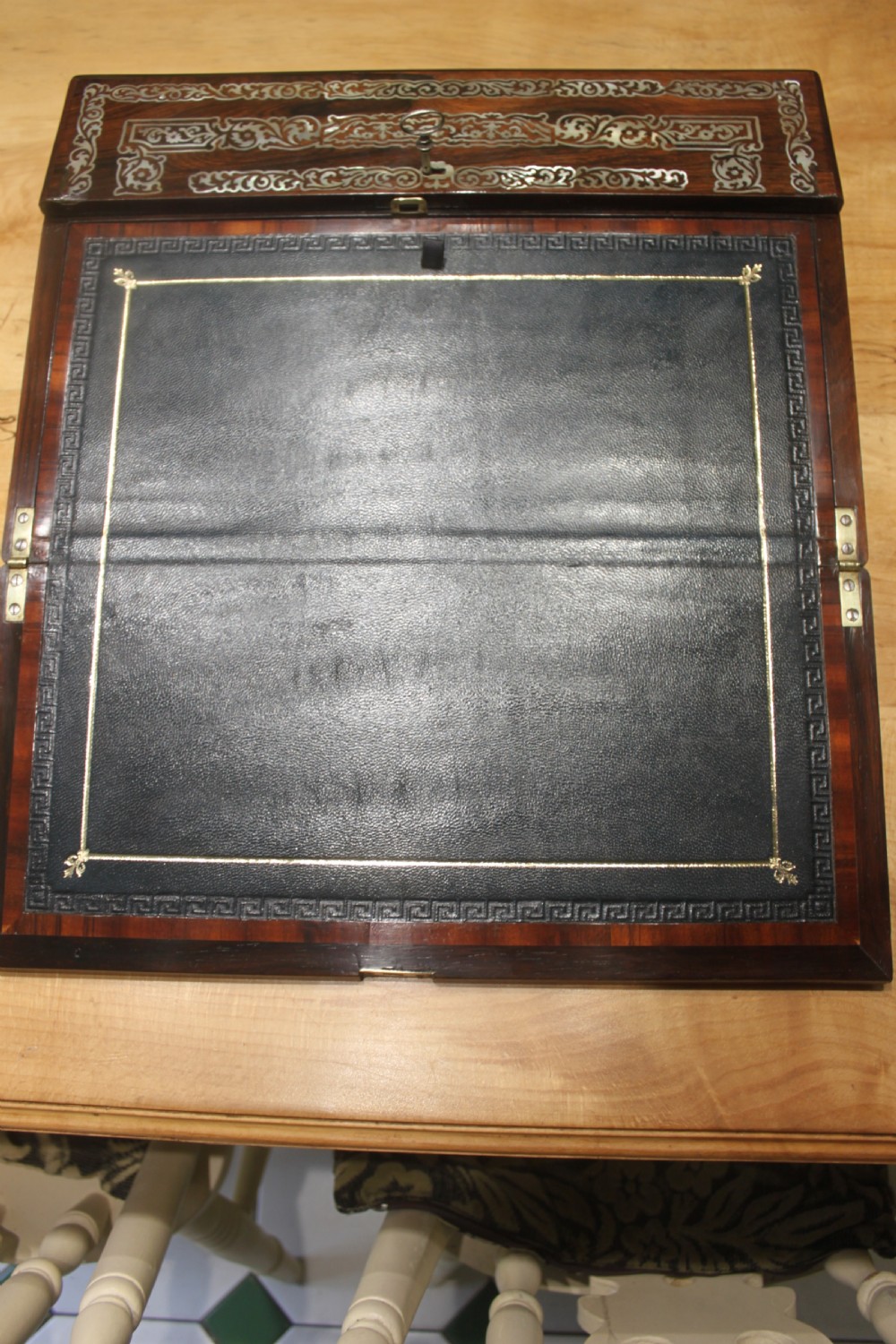 A dark rosewood rectangular writing slope box decorated with intricate mother-of-pearl foliate floral inlay and a central keyhole escutcheon. View VI