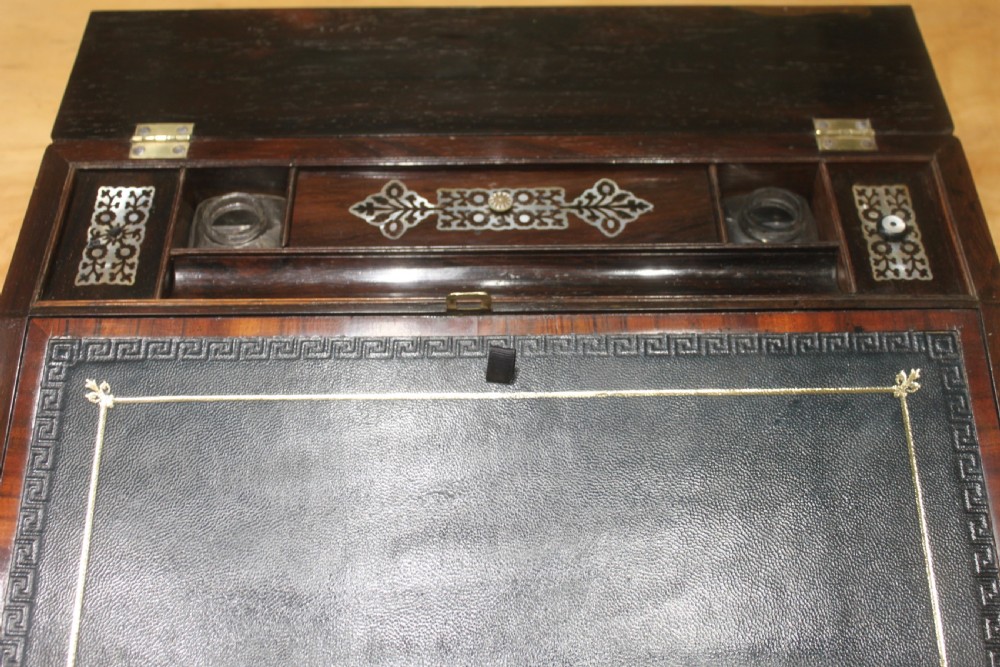 A dark rosewood rectangular writing slope box decorated with intricate mother-of-pearl foliate floral inlay and a central keyhole escutcheon. View VII