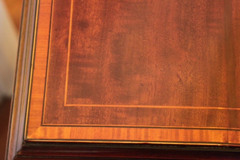 An Edwardian mahogany revolving bookcase featuring a central satinwood marquetry inlay top, slatted sides, open shelves, and castors. View VII