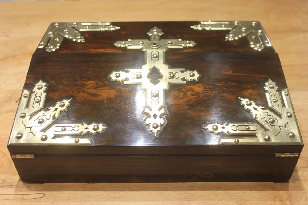 A rectangular dark coromandel wood writing slope box decorated with ornate Gothic Revival brass corner mounts and central brass straps. View II