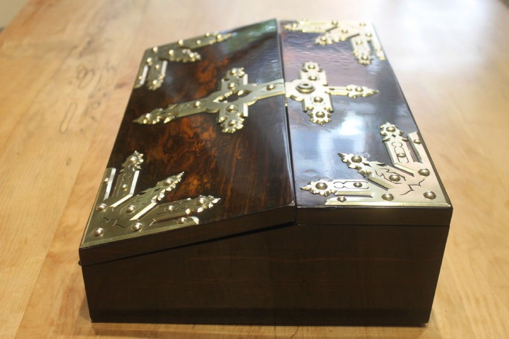 A rectangular dark coromandel wood writing slope box decorated with ornate Gothic Revival brass corner mounts and central brass straps. View V