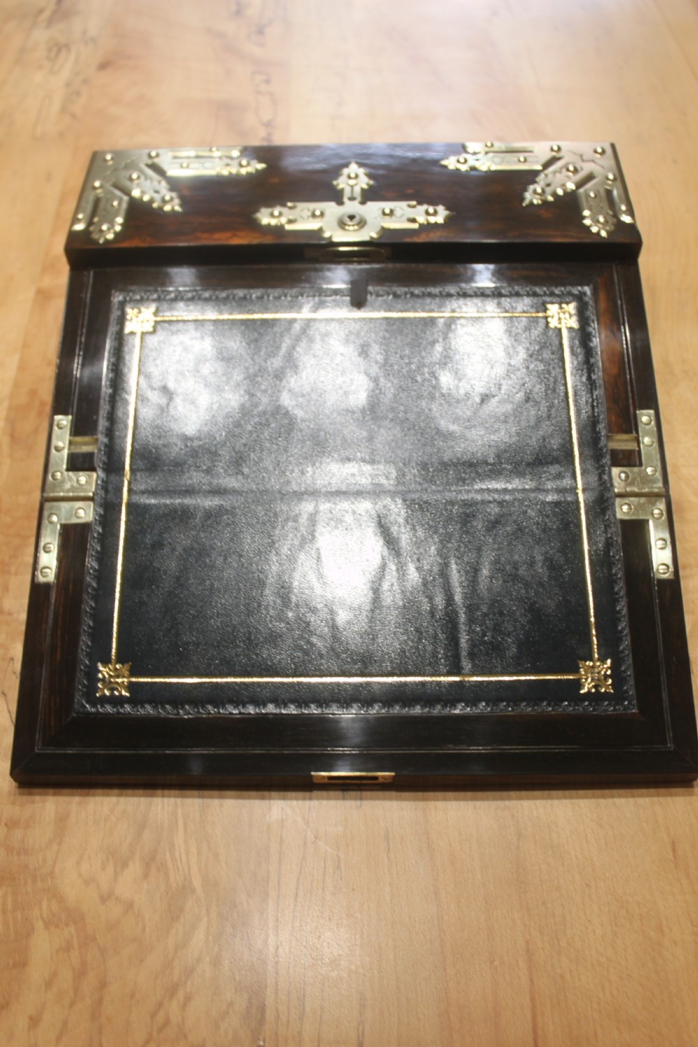 A rectangular dark coromandel wood writing slope box decorated with ornate Gothic Revival brass corner mounts and central brass straps. View VI