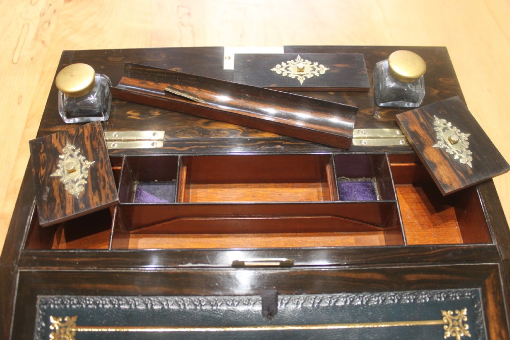 A rectangular dark coromandel wood writing slope box decorated with ornate Gothic Revival brass corner mounts and central brass straps. View IX