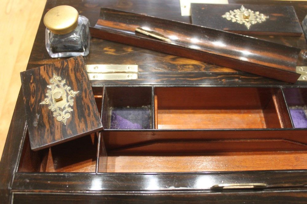 A rectangular dark coromandel wood writing slope box decorated with ornate Gothic Revival brass corner mounts and central brass straps. View X