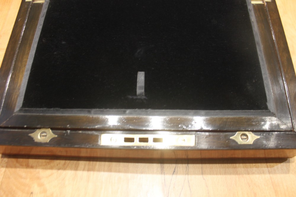 A rectangular Victorian burr walnut writing slope featuring a brass cartouche on top and a brass escutcheon with key on the front. View VIII