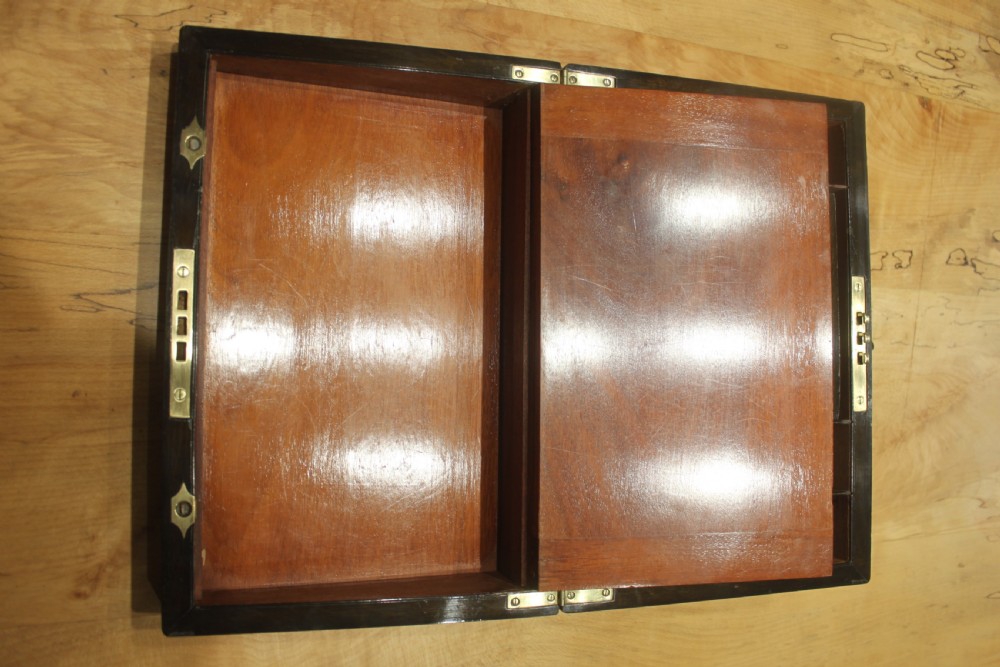 A rectangular Victorian burr walnut writing slope featuring a brass cartouche on top and a brass escutcheon with key on the front. View XII